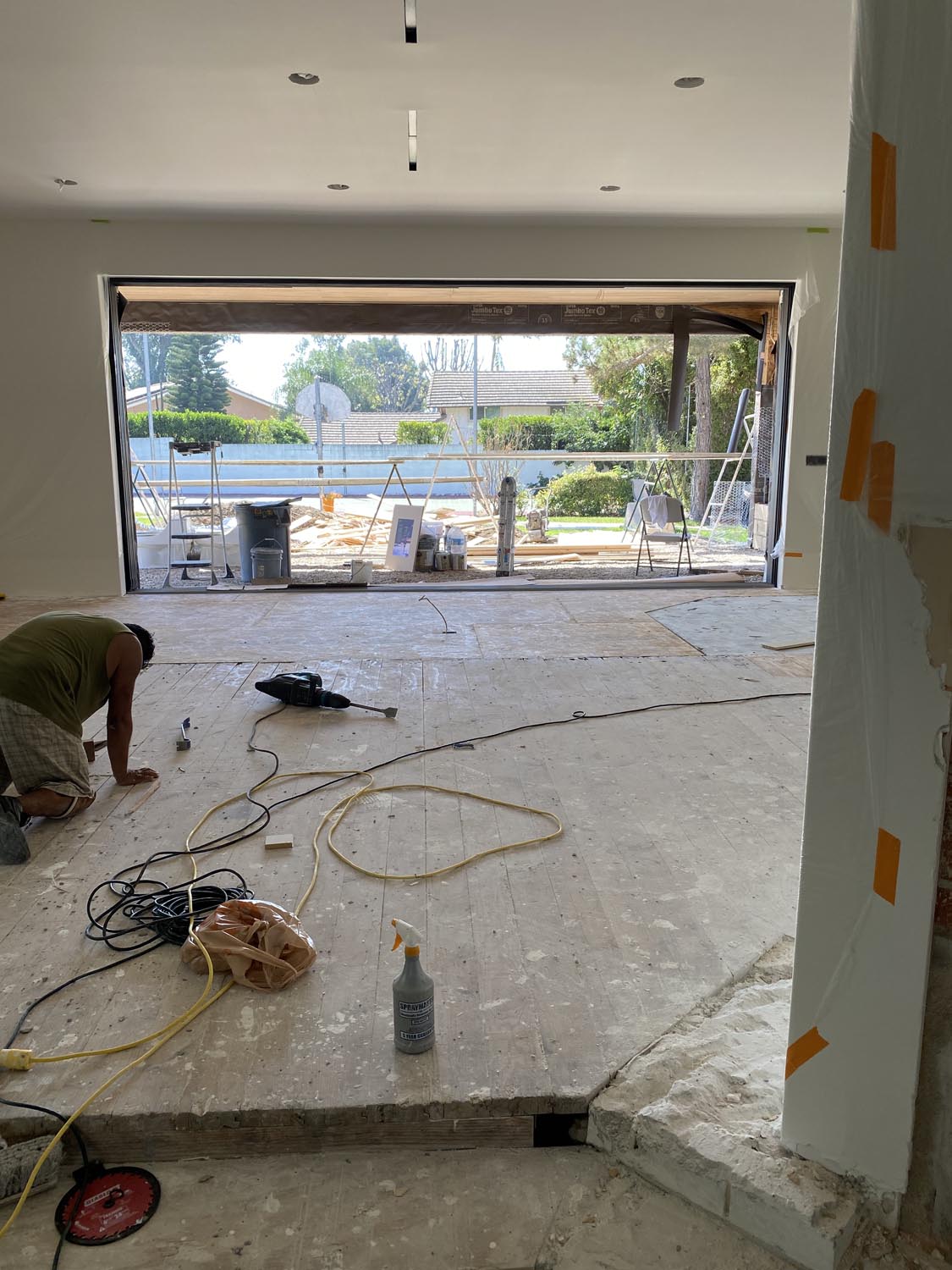 Reconstruction with stripped floors and sliding glass door opening in Villa Park, CA